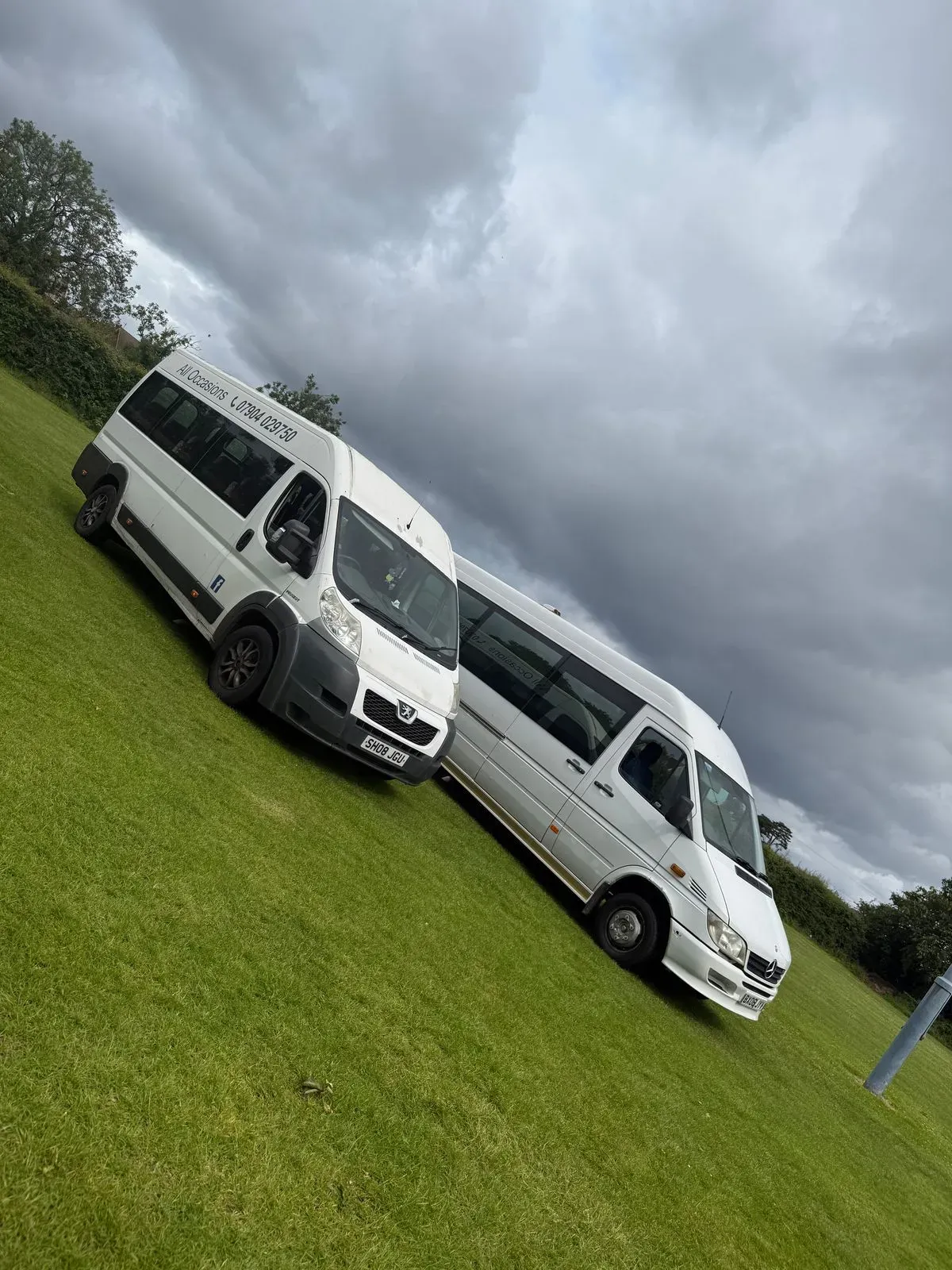Executive coach parked near Belfast City Hall at dusk